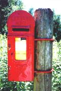 Small letter box attached to a post.