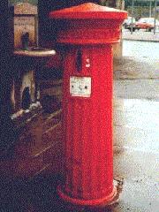 Fluted pillar box with vertical aperture.