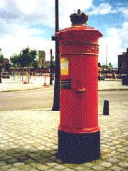 Large red pillar box with crown on cap.